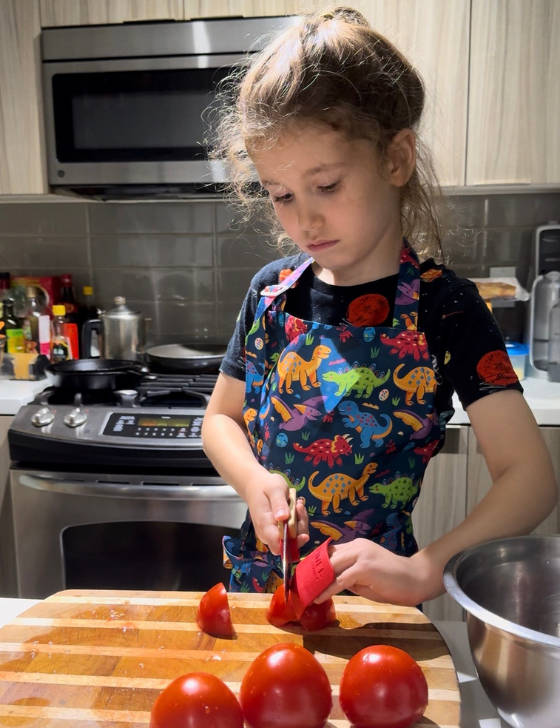 Carl's child joining in with cooking in the family kitchen