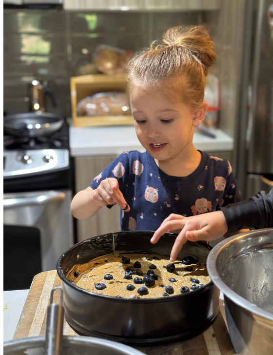 One of Carl's children helping out in the kitchen at Cracked Kitchen Window