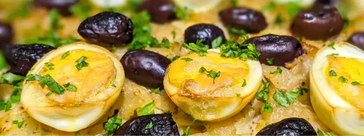 Bacalhau à Gomes de Sá made with salt cod, sliced potatoes, onions, boiled eggs, olives, and parsley baked in a traditional Portuguese style
